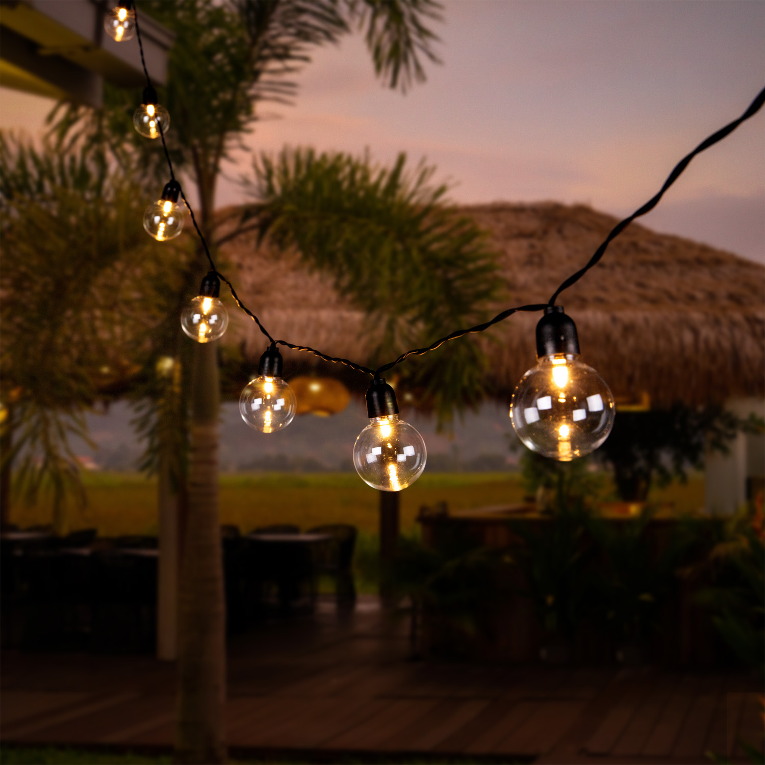 Beautiful pink sunset in the tropics. Street canopy from hay, kitchen area with rice field view.